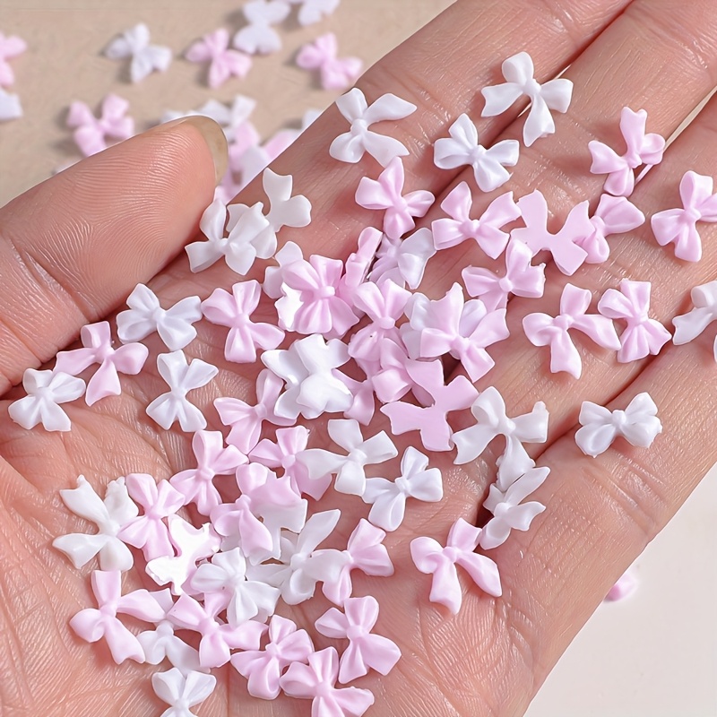 Image of 200pcs Of Assorted Resin Bow Nail Decorations In Pink And White, Perfect For Women's 3d Nail Art. Hypoallergenic Jewelry Supplies Nail Gem Additions And Decorative Bow Charms Made From Safe Materials