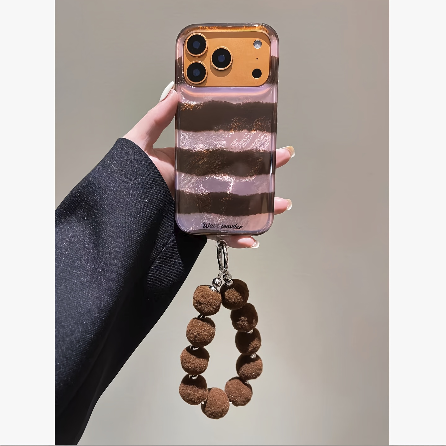TEMU Phone Case - A Retro-style Phone Case In Autumn And Winter Featuring A Lotus Root Pink And Brown Striped Design, Complete With A Brown Bracelet.