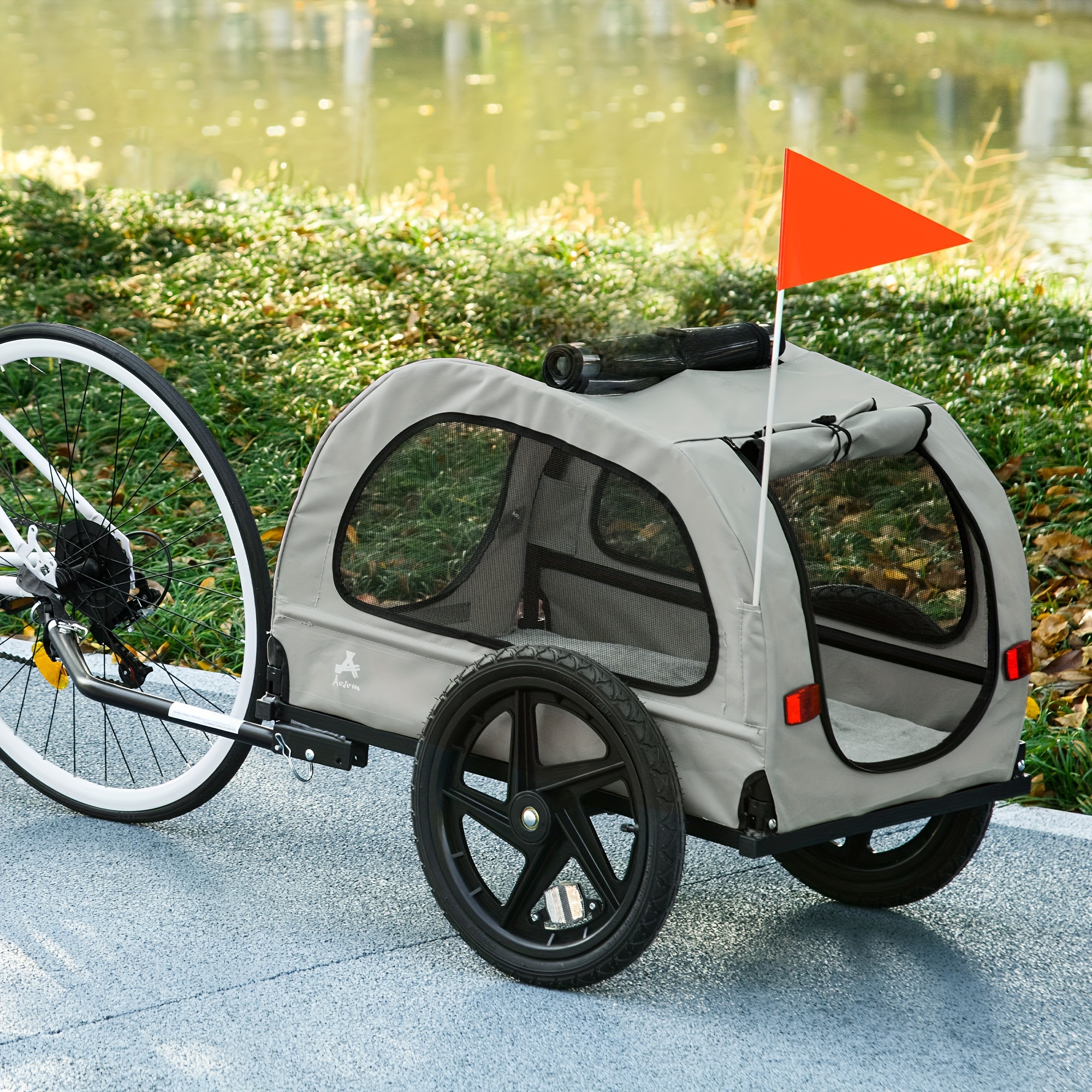   foldable dog bike trailer for medium dogs ventilated mesh windows safety leash flag front rear doors durable pet wagon with all terrain wheels light grey outdoor   sleek vehicle design   entries dog bike carrier