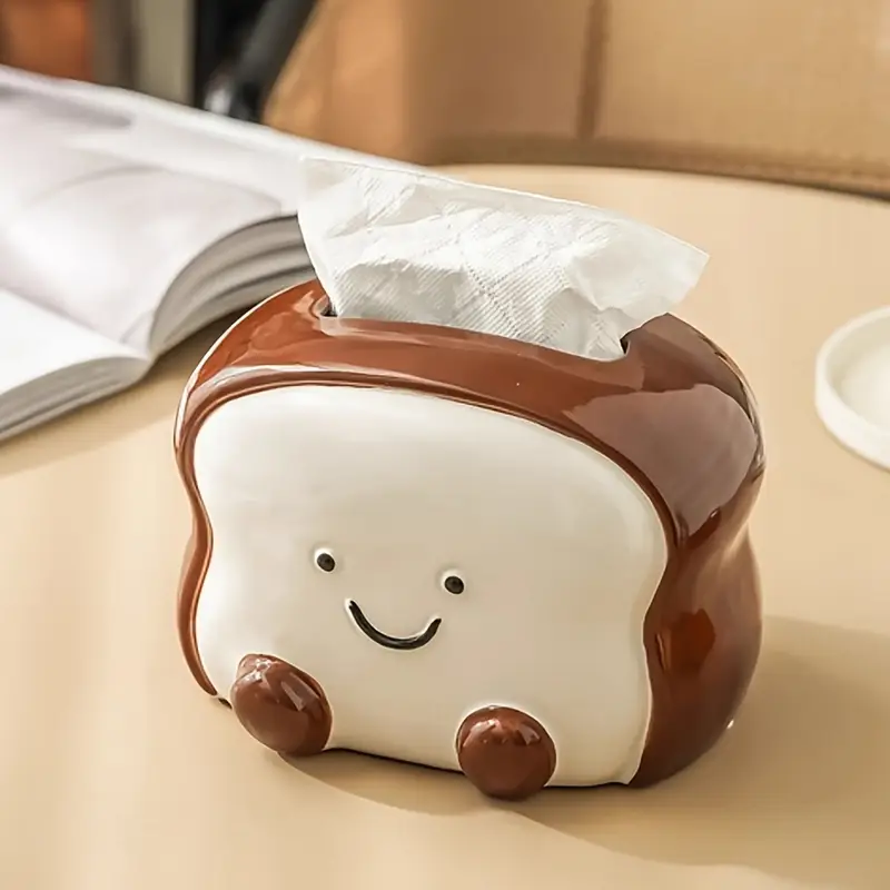 visually appealing toast shaped ceramic tissue box holder smiling bread design with pink flower detail accents living room bedroom or kitchen decor Product details 0
