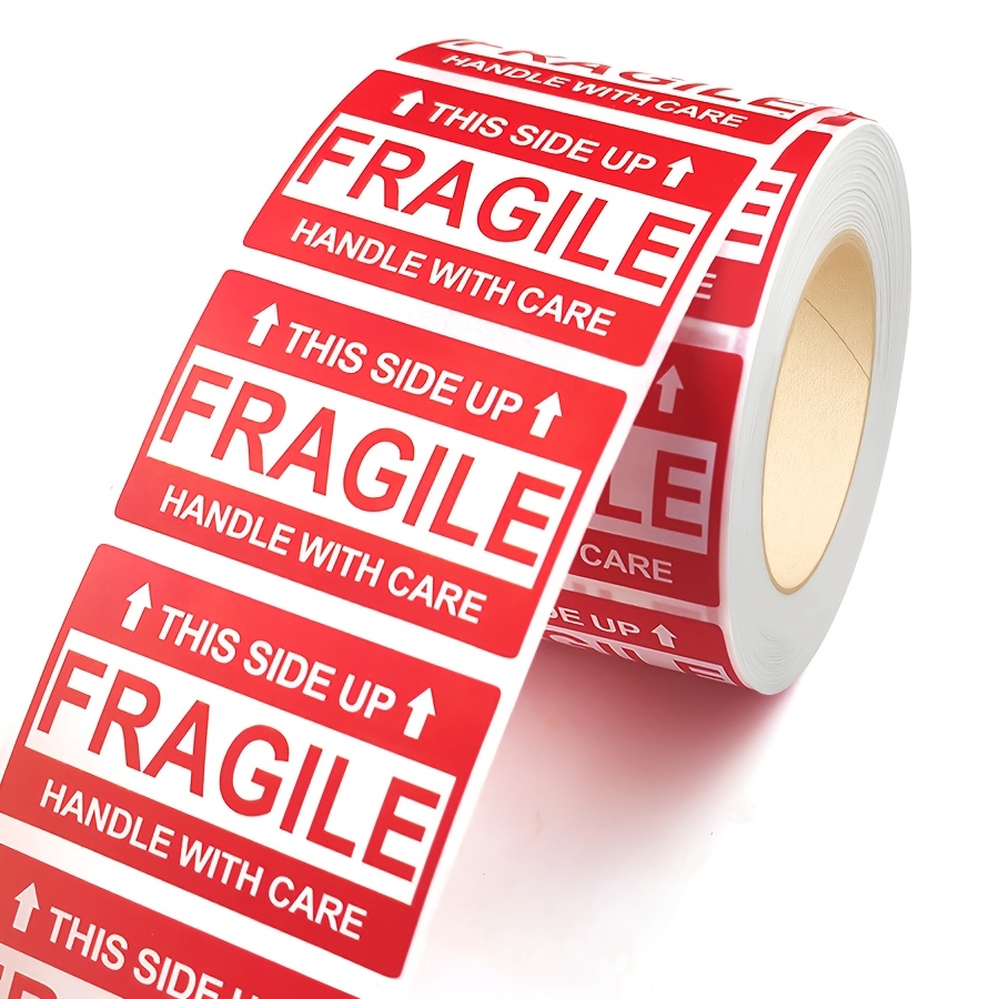 a roll of 500 fragile shipping warning labels featuring stickers that say   handle with care suitable for cardboard boxes packaging and parcel shipping