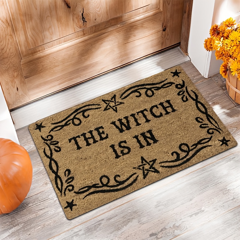 TEMU A Magical Doormat Featuring "the Is In", Material With. It Has A Brown Base With A Black Star And Spell Design, For Halloween