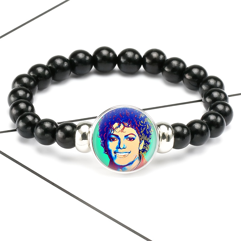 A Packaged Item ( Style Black Plastic Bead And Chain Bracelet), Featuring A Unique Of A Colorful Portrait Of Of A Round Badge