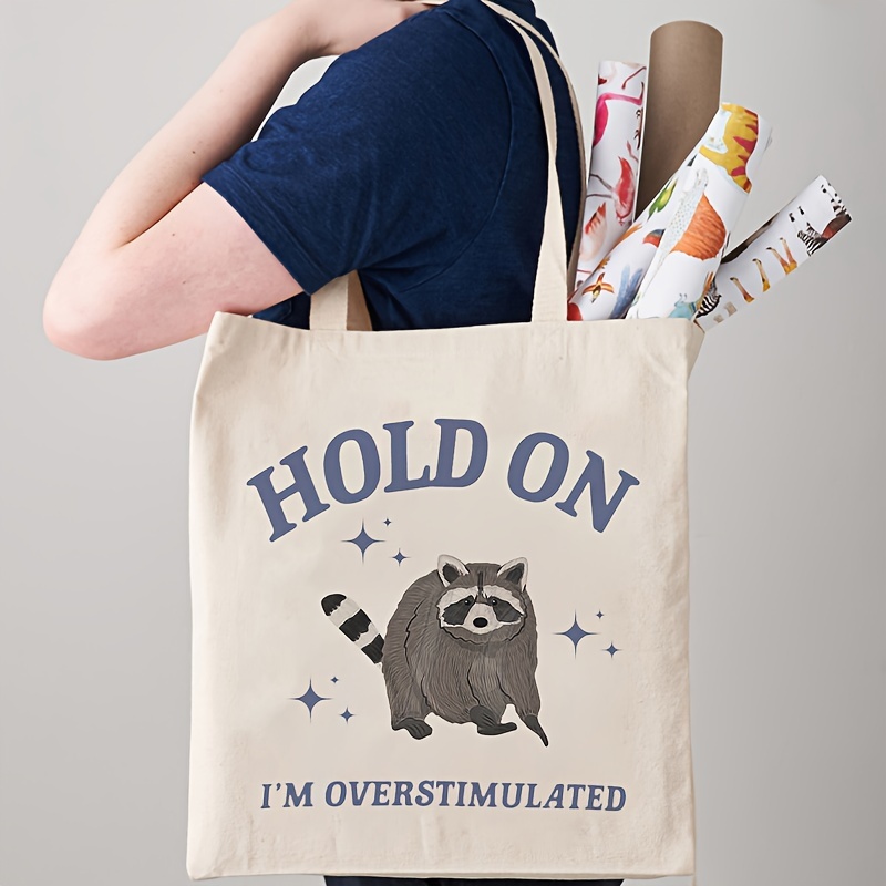 

1pc Hold On I'm Overstimulated Funny Raccoon Meme Pattern Tote Bag, Canvas Shoulder Bag For Travel & Daily Commute, Shopping Luggage Bag, Trendy Folding Handbag, Ideal Choice For Gift