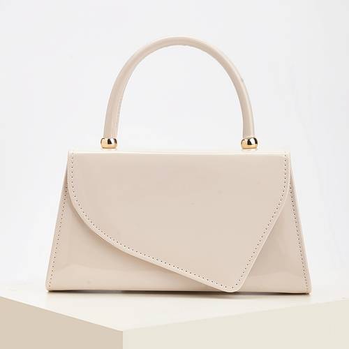 a stylish handbag for of smooth leather in a single color featuring an asymmetrical flap design beautiful and minimalist