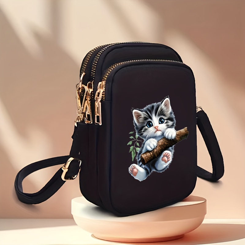 TEMU 【商品名】遊び心と可愛さのある猫のデザインが特徴のコンパクトなクロスボディバッグ。日常の通勤やカジュアルなお出かけに最適な複数のポケット付き。ゴールデンファスナー、調節可能なショルラップ、コイン収納、ヘッドホンが付属。