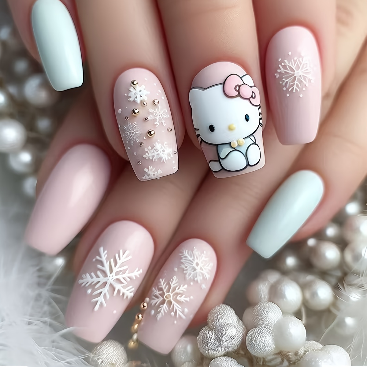 A Set Of 24 Hello Kitty-inspired Nail Designs Featuring Predominantly Soft Pink And Light Blue Colors. Some Nails Showcase Hello Kitty Images, While Are With Snowflake And , A And Look