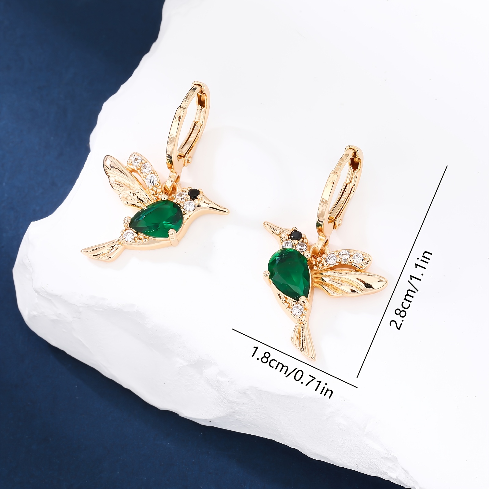 A Pair Of Stylish Earrings Featuring Water And Hummingbirds