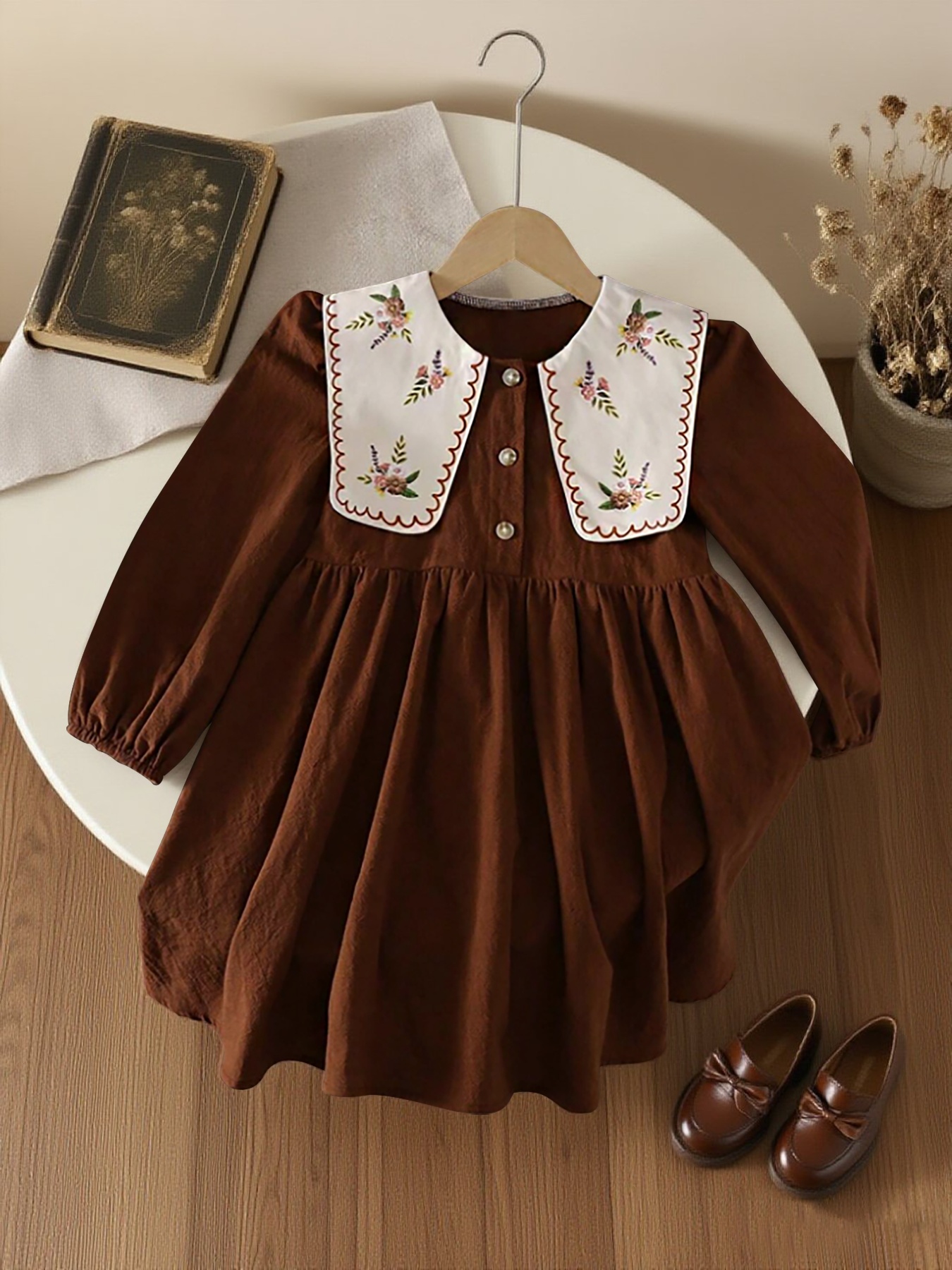 A * of Fashionable Spring And Autumn Dresses for Girls, Featuring a Quiet,  Cute, Sweet, Elegant, And *. It Has a Pleated Hem, Floral Embroidery, a  Doll Collar, And Long Sleeves, Making It * Daily *