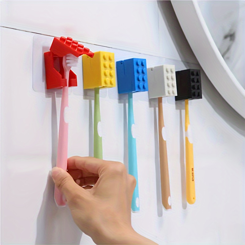 

1pc Wall-mounted Toothbrush Holder, Plastic Construction, Dustproof, Manual Stick-on Installation, No Electricity Needed