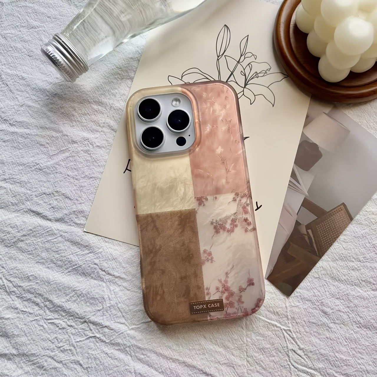 A Phone Case Featuring a Four-Color Stitching Pattern That Incorporates Bamboo, Orchids, Calligraphy, And Plum Blossoms, Compatible with iPhone Models 13, 14, 15, And 16 Pro Max.