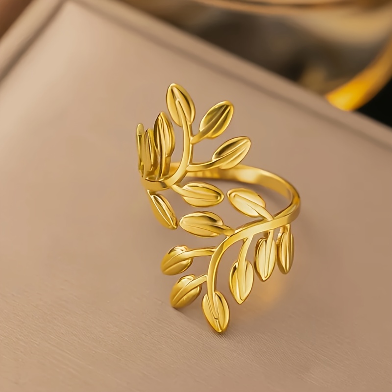 a stainless steel adjustable   for women featuring a vintage   with golden and silvery leaves embodying a fashionable and minimalist aesthetic