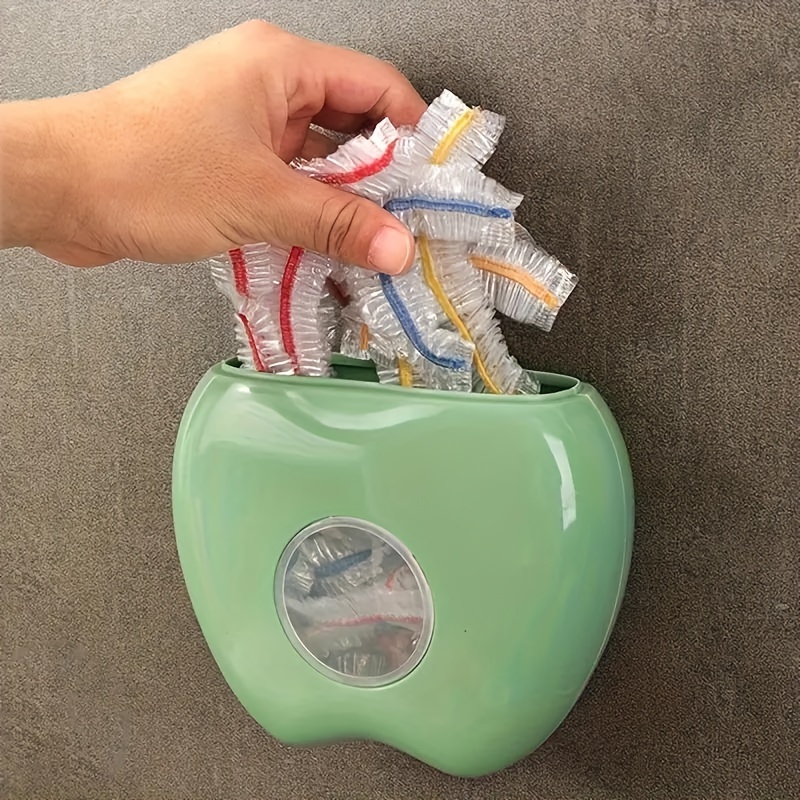 1 vnt. obuolio formos prie sienos montuojamas plastikinių maišelių dozatorius, elastingas apvyniojimo organizatorius virtuvei ir vonios kambariui, vietą taupantis laikymo sprendimas su greitu maišelių pasiekimu, pagamintas iš patvarios plastikinės medžiagos