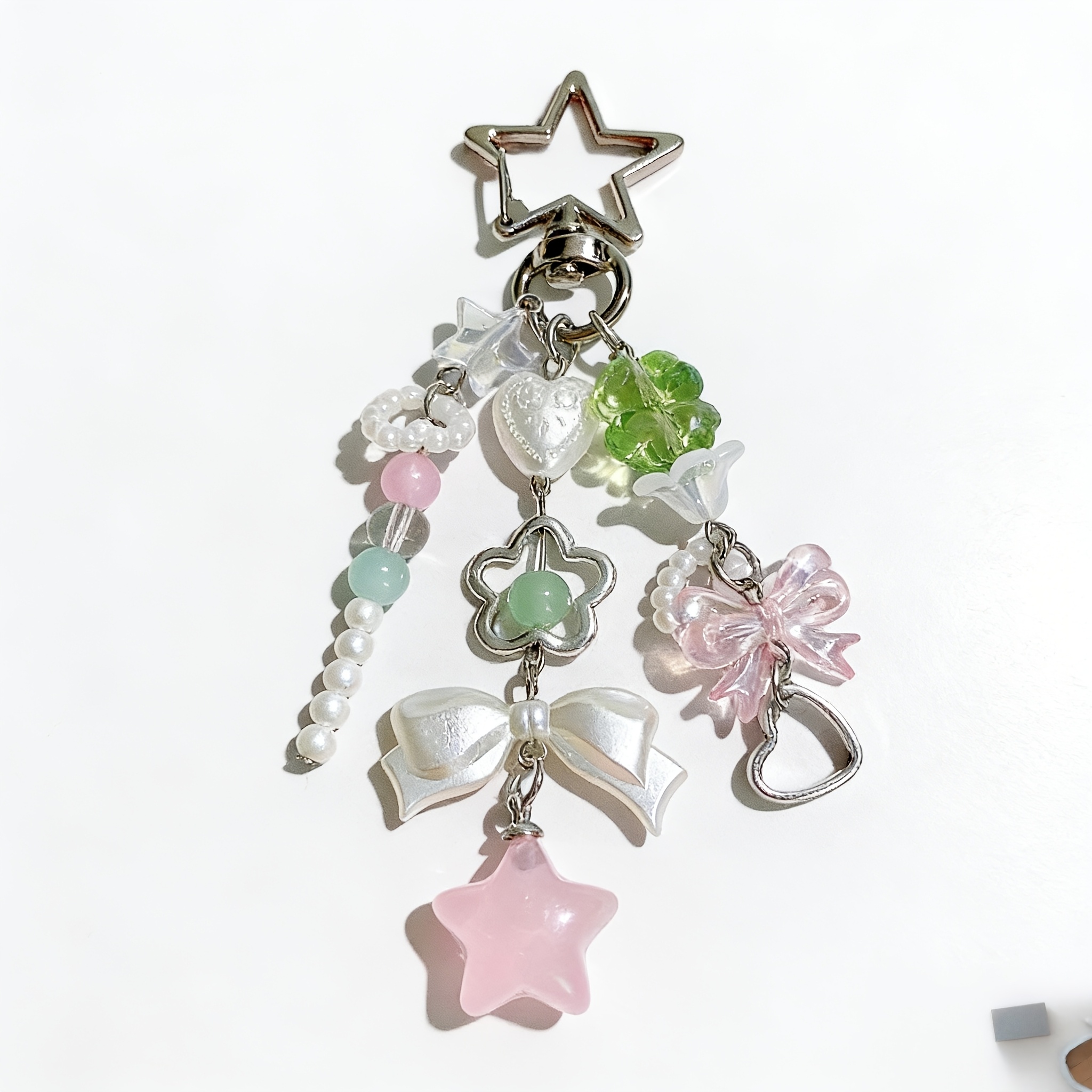 A Pink Mobile Phone Or Bag Charm Featuring An Instagram-style Star, A Bow, And A Clover; This And Elegant Accessory Makes A Wonderful Gift For , , Or