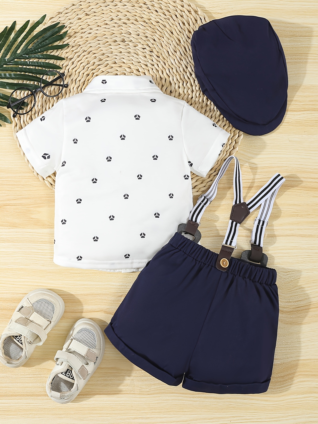 a formal three piece gentleman outfit for baby boys featuring a short sleeve shirt with geometric patterns and a bow tie shorts with suspenders and a   hat stylish and   its a   for summer birthday parties Product details 1