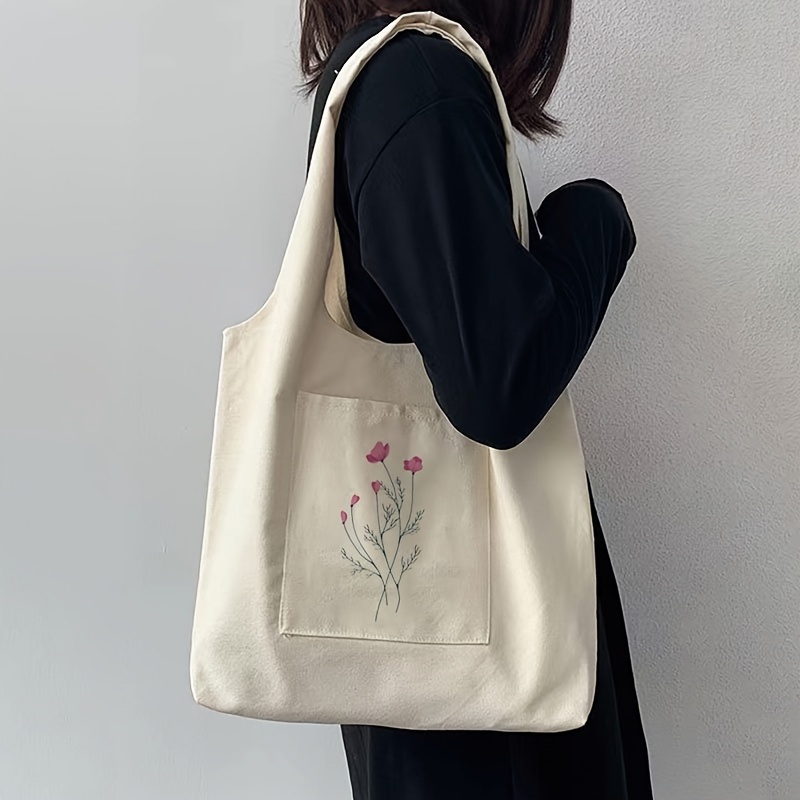 Image of A Stylish And Easy Beige Tote Bag With A Plant Print, Perfect For , Serving As A Spacious Shopping Bag Or A Canvas Bag For Students To Carry Their Stationery