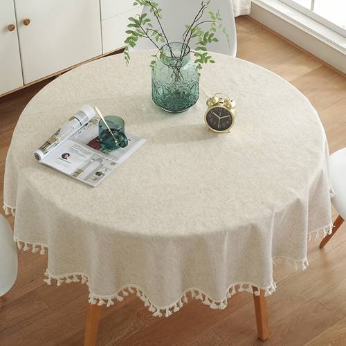 a beige round lace tassel tablecloth made of bamboo fiber