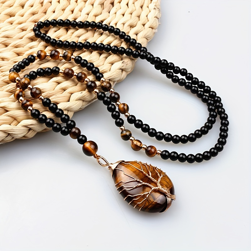 

Bohemian Eye Of Life Pendant Necklace For Men And Women – Handcrafted Beaded Jewelry With Oval Amber Stone And Golden Accents, Black And -orange Design