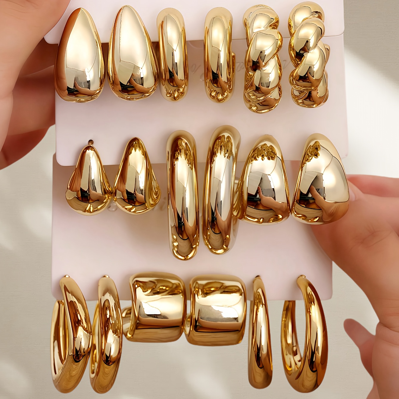 a collection of c shaped earrings with a golden   size 3 9