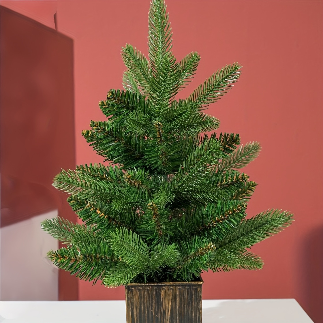 Image of 1 Small Fake Christmas Tree With A Stand. A Festive Item Suitable For Holiday Decorations Or As A Gift. You Can Ornaments On Like