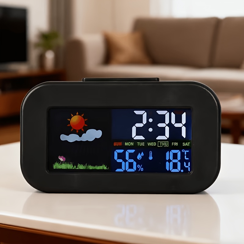 E-shop Ein Drei-in-Eins Desktop-Wecker mit Farbbildschirm, der Temperatur, Luftfeuchtigkeit und Wetter anzeigt. Er verfügt über einen großen,