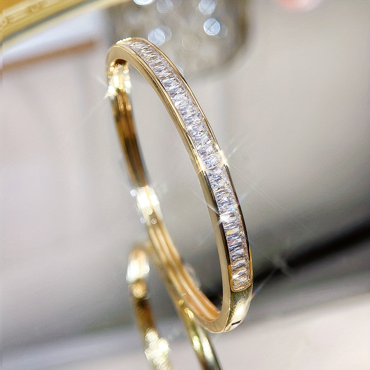 

A Stylish And Golden Bracelet For Women, With White Synthetic Zirconia, Attire And Accessories.