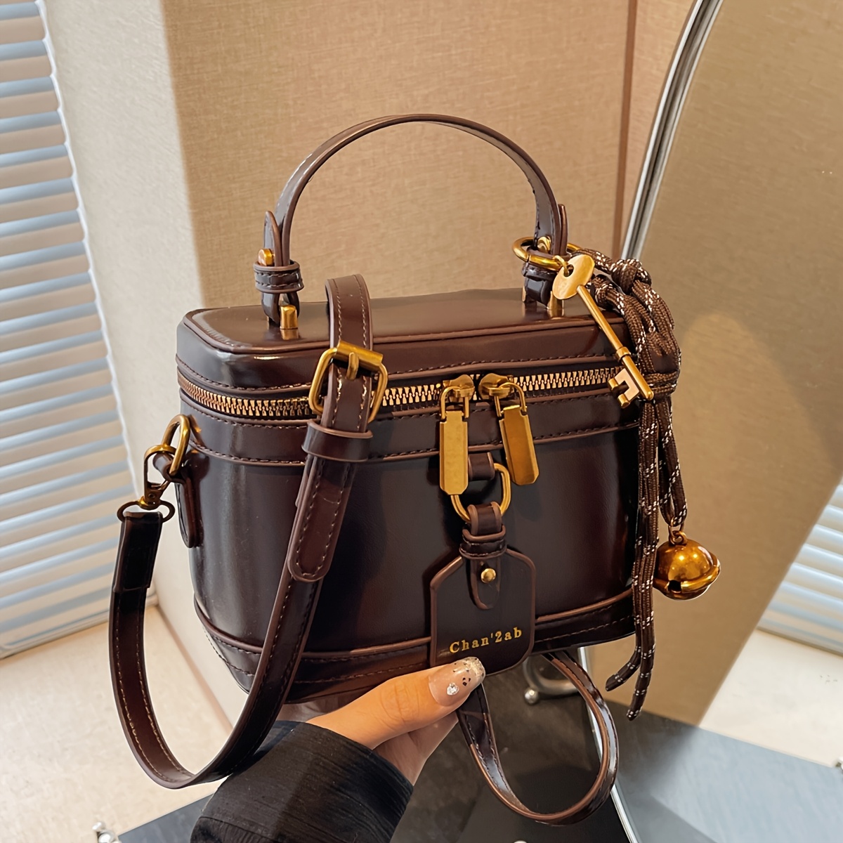 Elegant Retro Women's Crossbody Bag with Bell Pendant – Stylish Brown Handbag with Adjustable Strap, Zipper Closure, and Golden-Tone Hardware for Work, Date, Shop, and Party