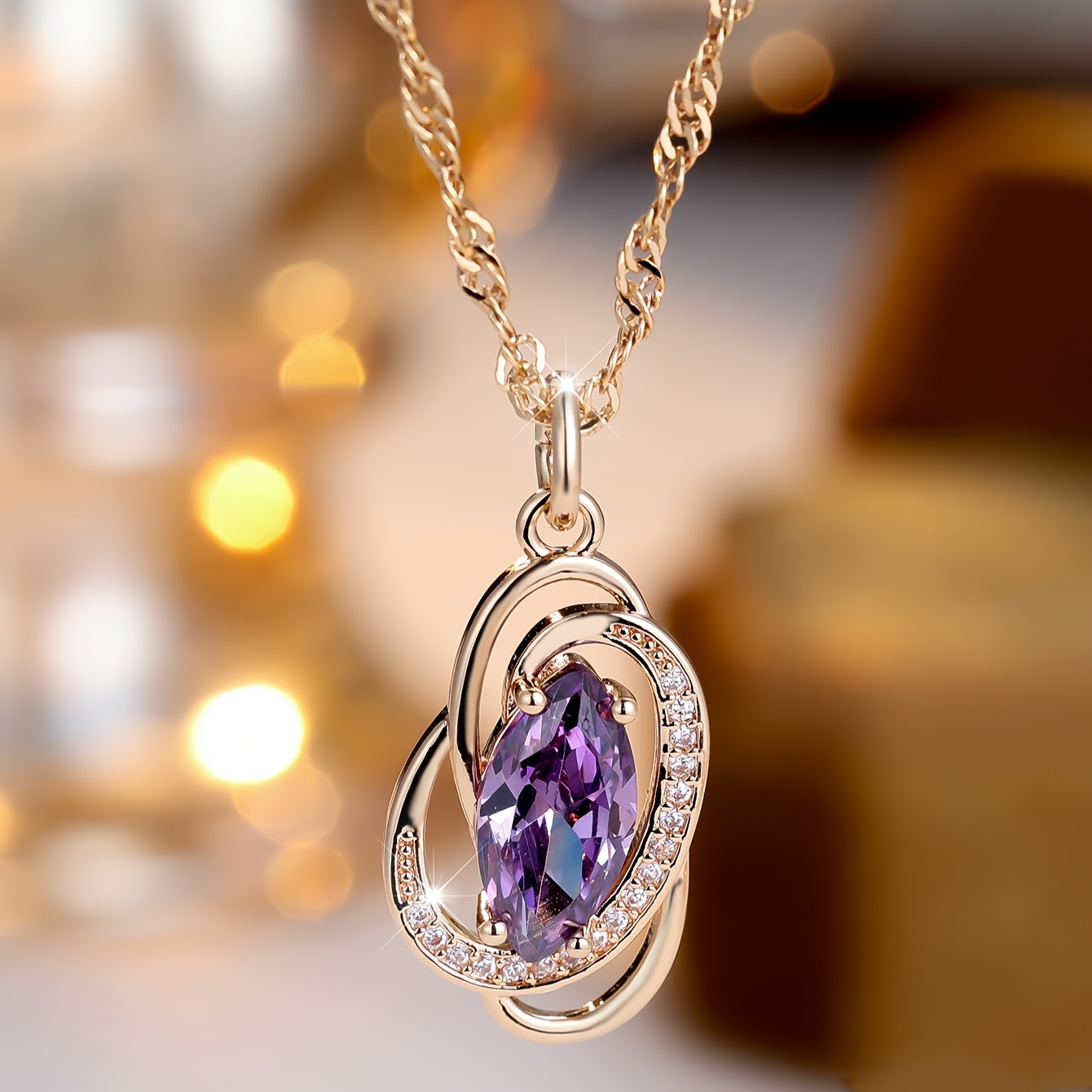 Image of A Single Piece Of Luxurious Jewelry Featuring A Golden Oval-cut Purple Stone Pendant, Perfect For Weddings And As Stackable Gifts
