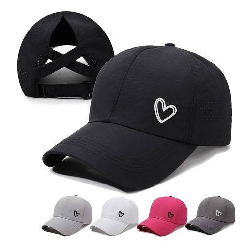 a solid color heart shaped baseball cap with an adjustable snapback strap designed for wearing with a high ponytail tied the back features a breathable mesh panel at the back in white black gray rose red suitable for golf
