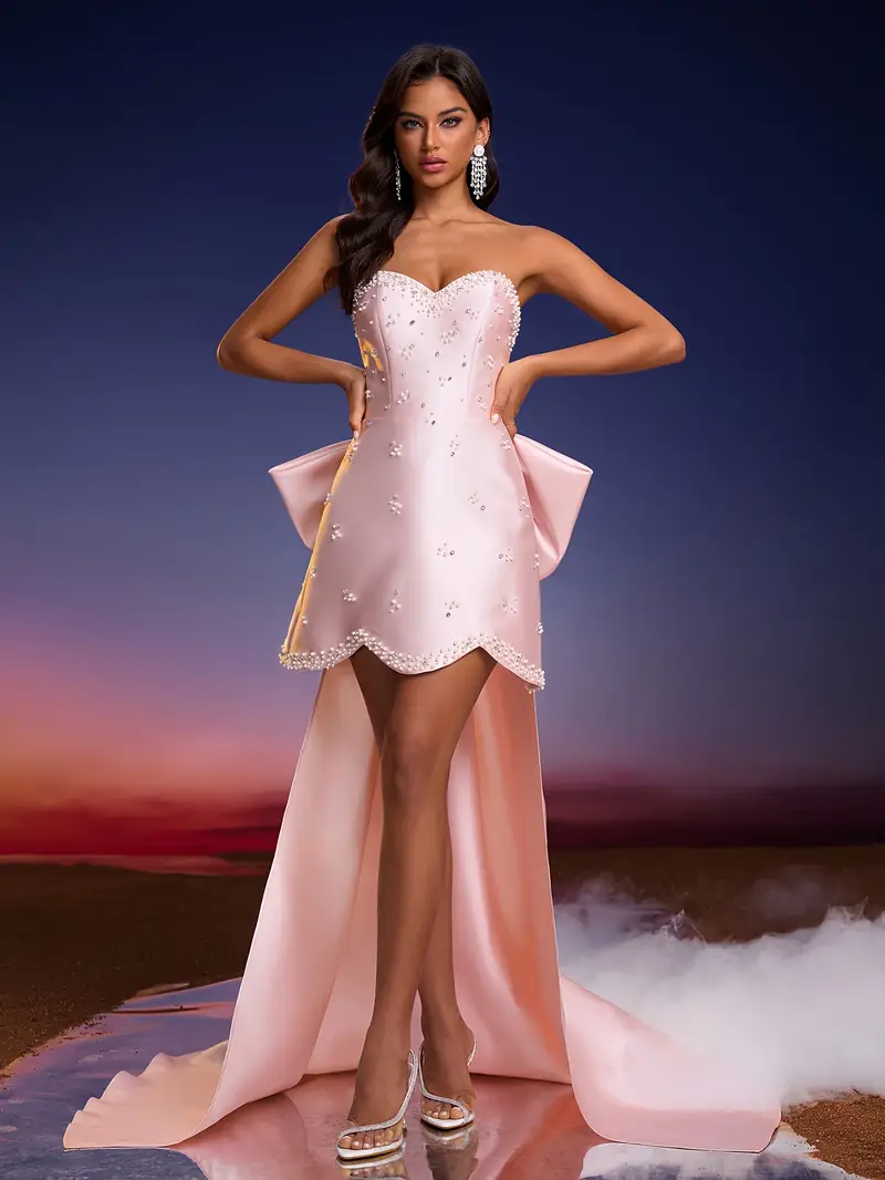 A Pink Dress * with a Large Bow on The Back, Featuring an Elegant Strapless Design with Pearl And * Embellishments * Women Attending Evening Events, Parties, Or Family Dinners A Pink Dress * with a Large Bow on The Back, Featuring an Elegant Strapless Design with Pearl And * Embellishments * Women Attending Evening Events, Parties, Or Family Dinners