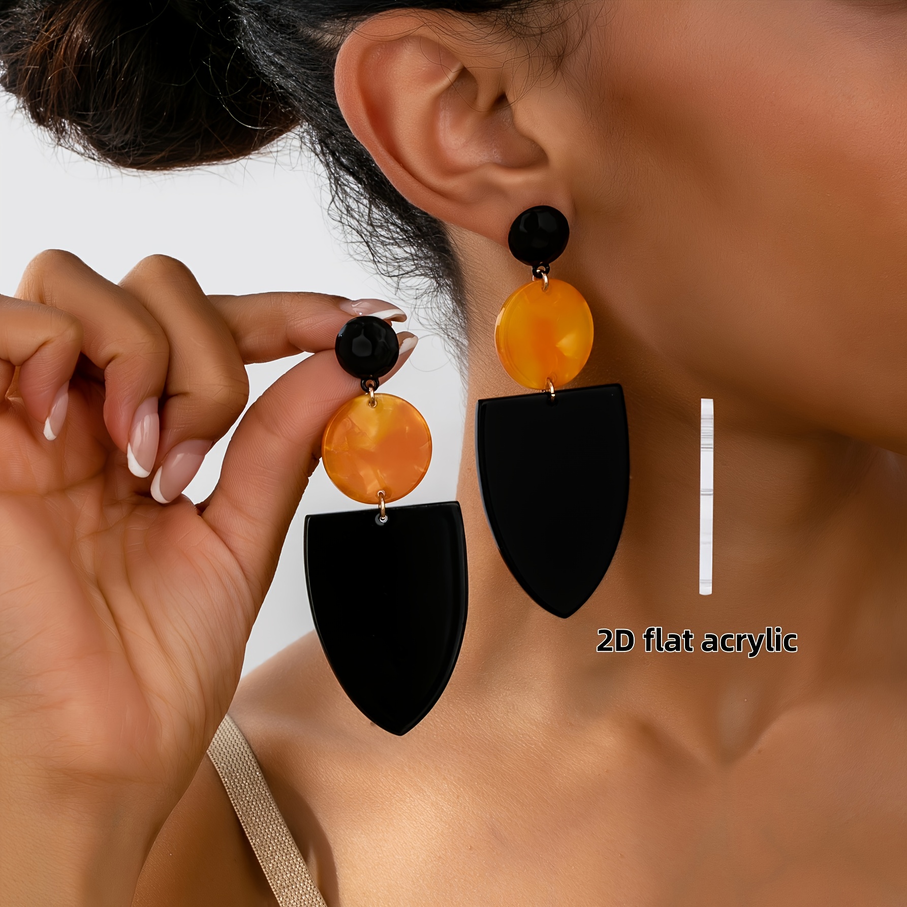 A Pair Of Bohemian -style Black And Orange Drop Earrings Featuring , Round , Perfect For Vacation And Casual Attire