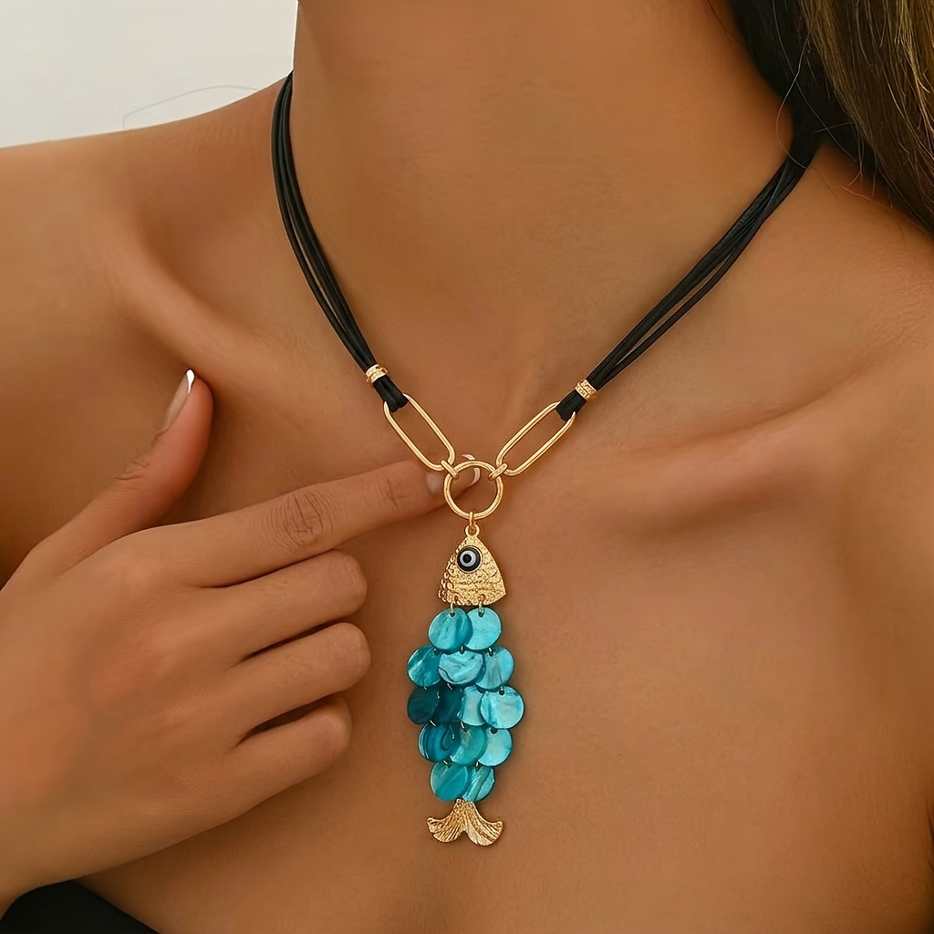 TEMU 1 Bohemian Style Fish Pendant Necklace. Features A Black Multi-strand Rope Chain With A Golden Clasp. The Pendant Is -dimensional Small Fish