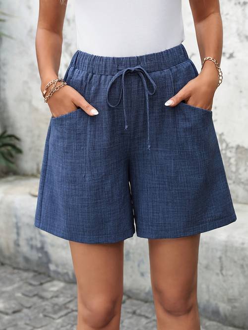 a pair of womens solid color loose fitting casual shorts with pockets for a comfortable summer wear