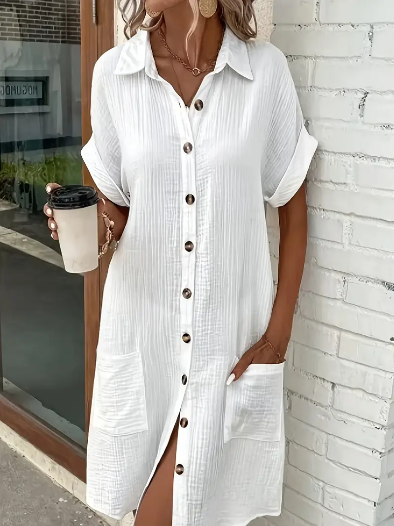 a minimalist white shirt dress made of breathable featuring a sharp collar design and buttons that add a touch of details 24