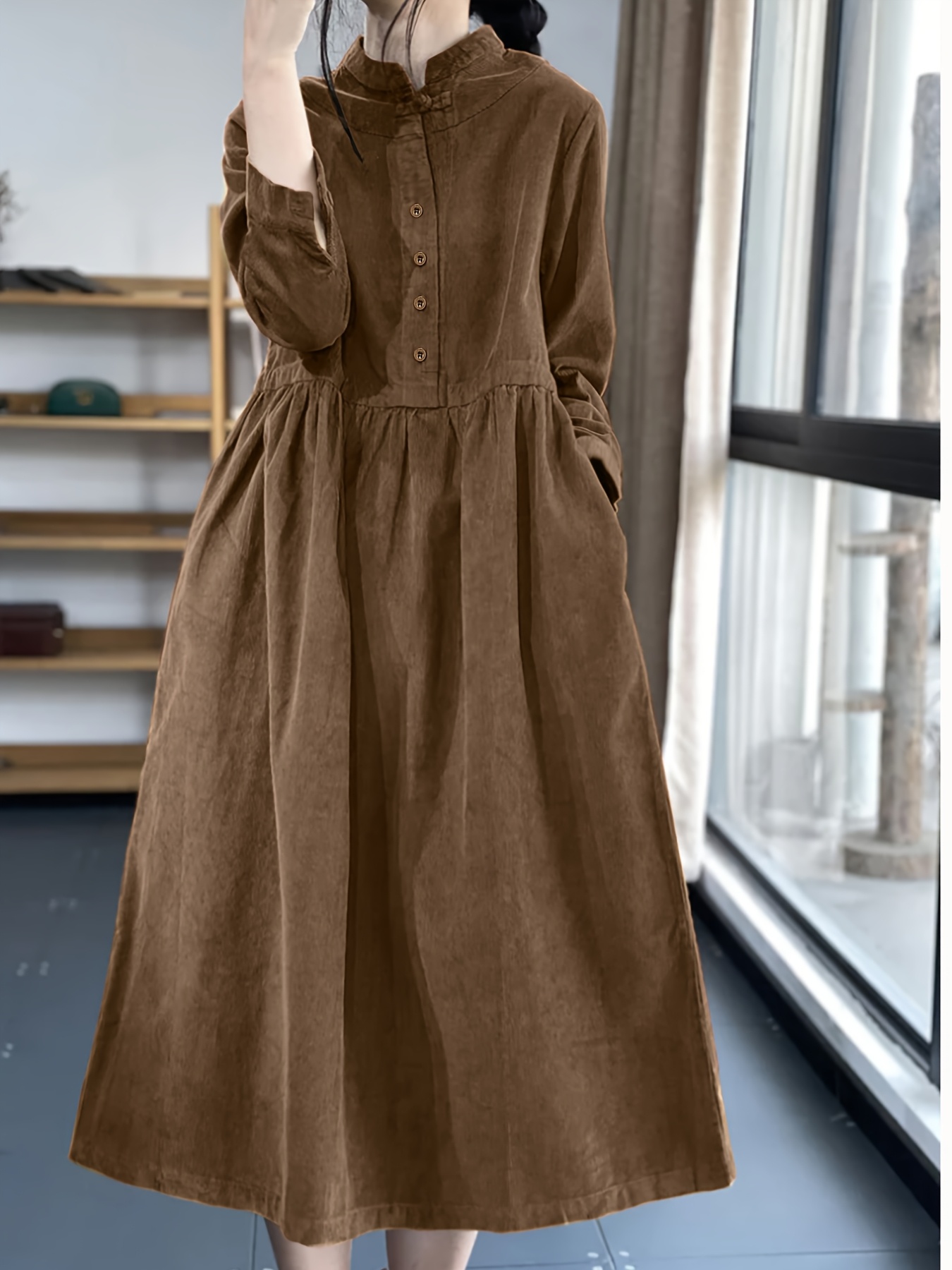 Model wearing a stunning retro Chinese style maxi dress in soft polyester featuring a stand collar button detailing and long sleeves Perfect for autumnwinter