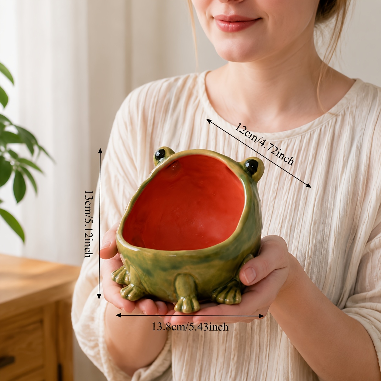 Green frog-shaped container with an open red mouth