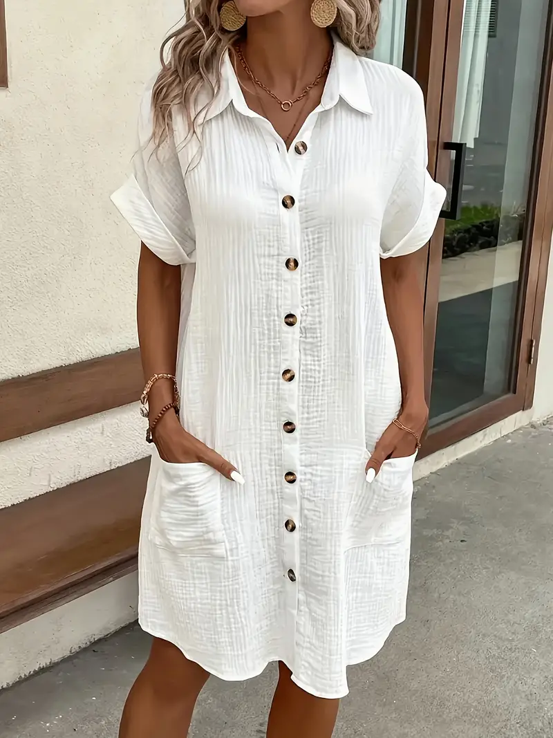 a minimalist white shirt dress made of breathable featuring a sharp collar design and buttons that add a touch of details 23