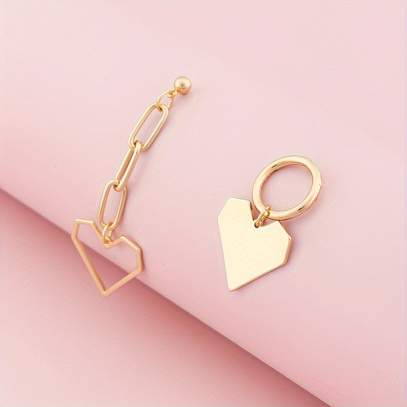 A Pair Of Designed Vintage-style Geometric Heart Asymmetrical Earrings With A Minimalist Aesthetic