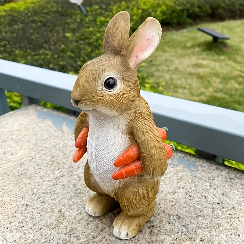 a fun rabbit statue with a carrot made of resin   easter suitable for indoor and outdoor garden decoration ideal for display on garden patios lawns and   animal sculpture