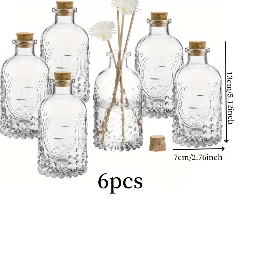 Clear Glass Bottles Featuring A Vintage Embossed Design, Complete With Cork Lids, Perfect For Use As Apothecary Flower Bud Vases