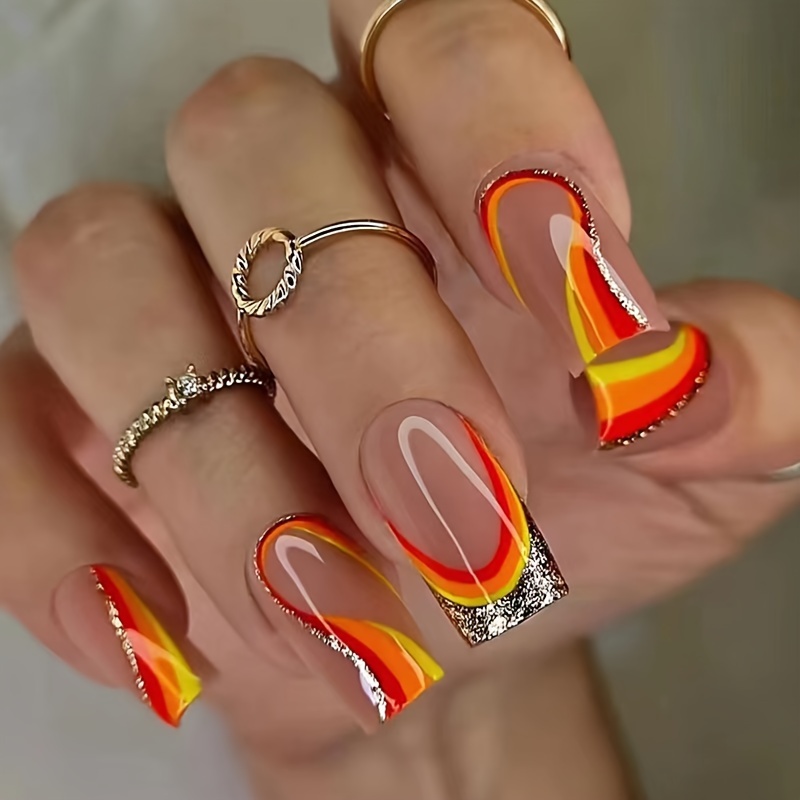 

24 Pieces Of Medium Length, French-inspired, Glittery Nail Art With Red, Yellow, And Orange Stripes - Perfect For A Festive Look!