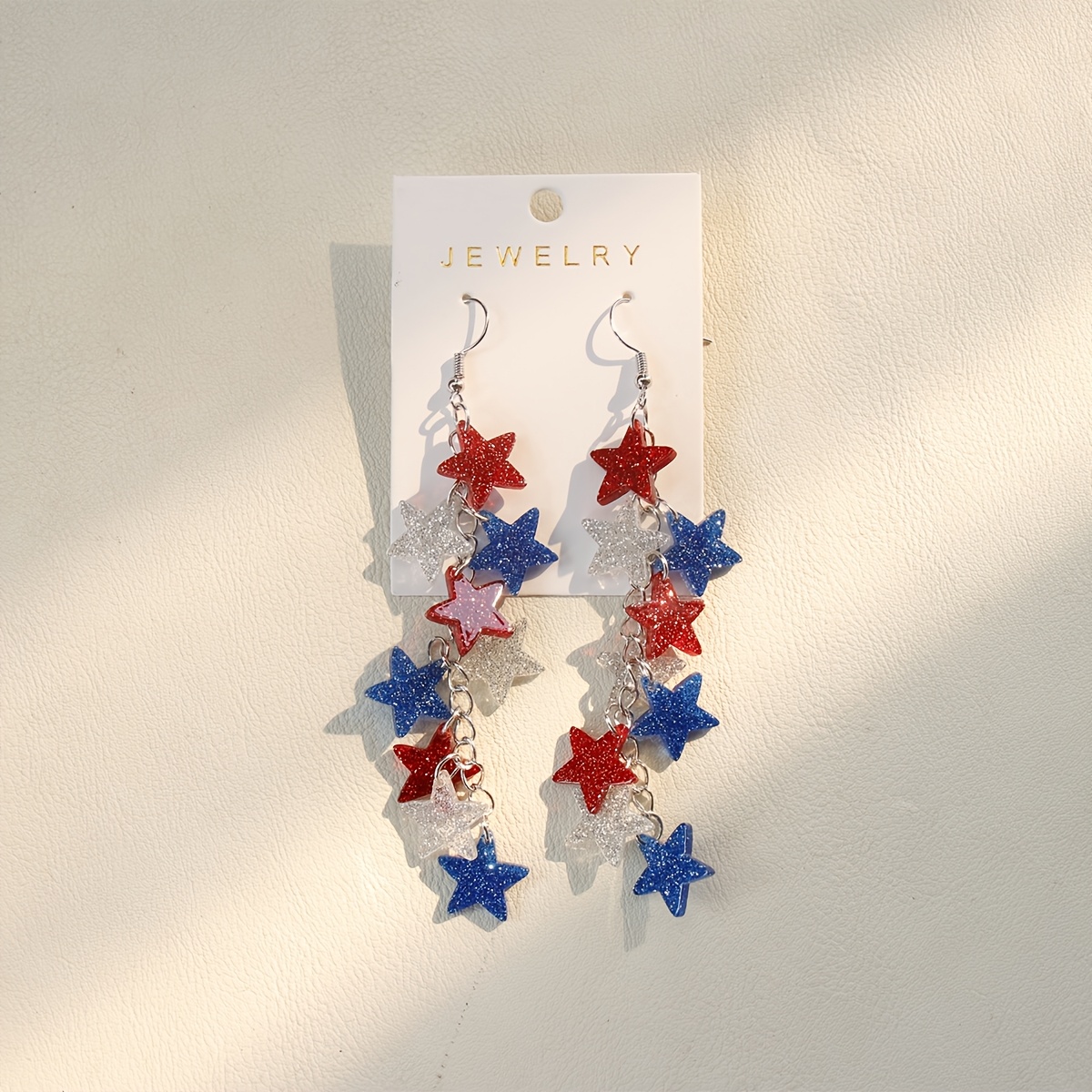 a pair of long acrylic pendant earrings featuring     stars perfect as a party gift for women