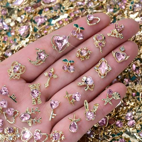 30pcs of luxurious nail art decorations in golden shapes featuring pink diamonds and designs such as flowers butterflies hearts and stars valentines day embellishments