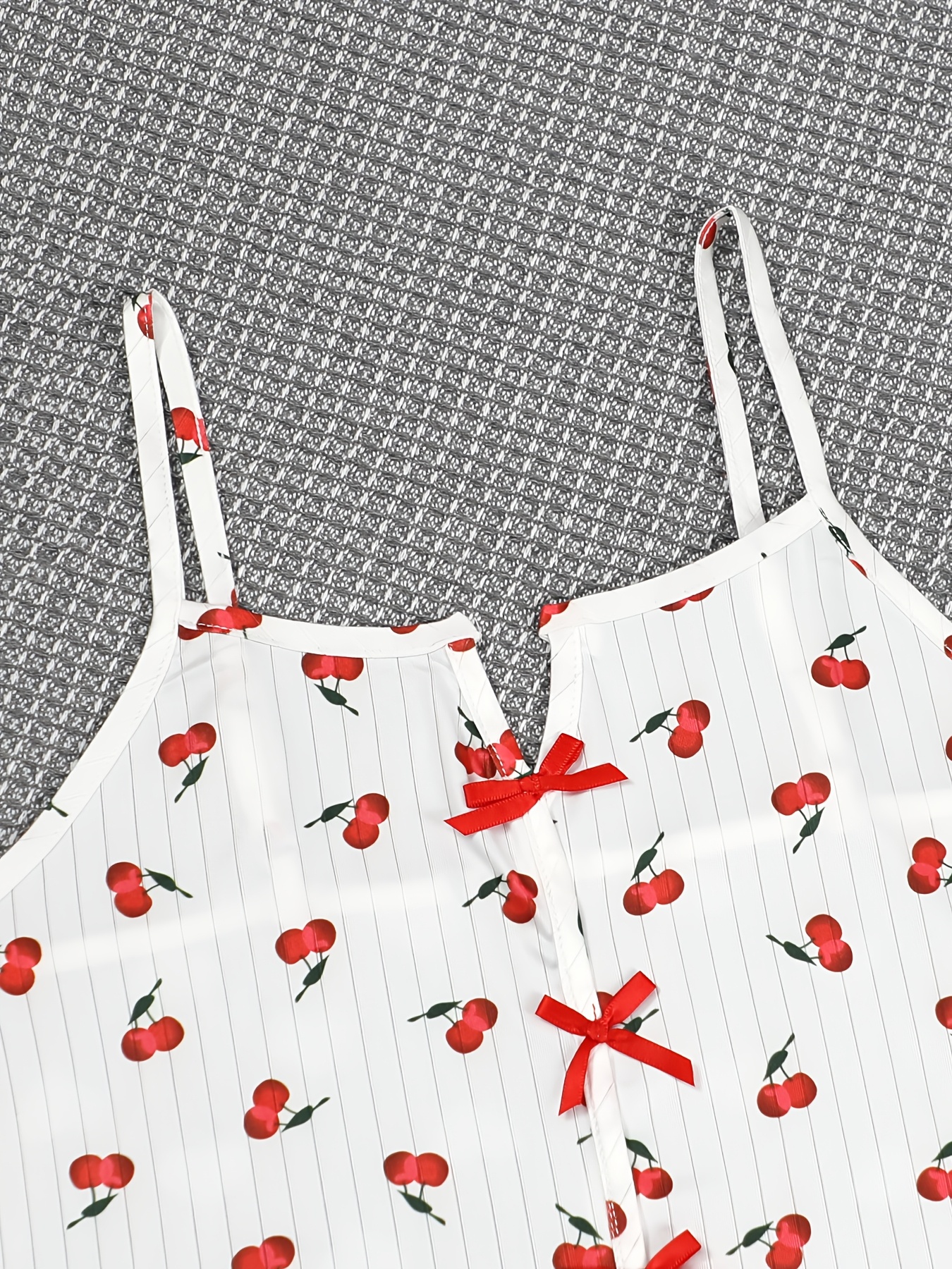 Elegant And Comfortable Women'S Pajama Set Featuring a Sexy Spaghetti Strap Design with a Bow, Open Back, And Cherry Fruit Print Long Pants, Tailored for The Middle Eastern Market.
