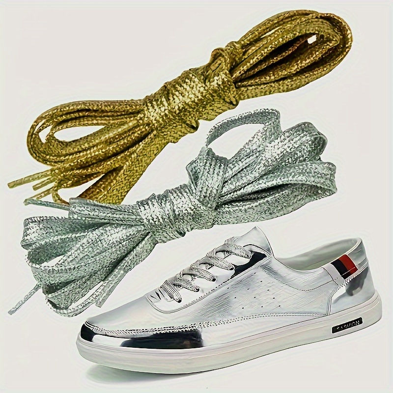 

A Pair Of 1/ Of Combination Golden Silvery Fashion Sneakers With Flat Shoelaces, Suitable For Shoe Styles For Men And Women.