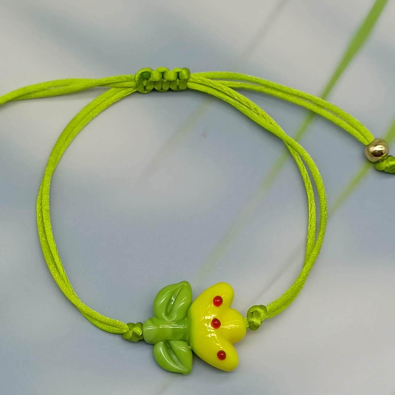 Glass Bead Bracelet with Yellow Flower Charm & Green Beads