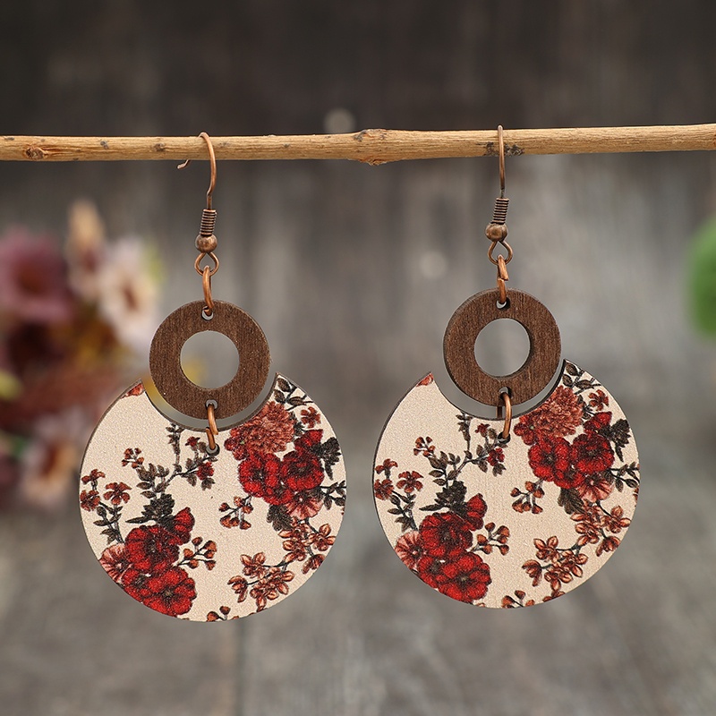 A Pair Of Vintage-style Crescent-shaped Earrings With A Of Floral Prints, Pieced In A Circular Openwork Design