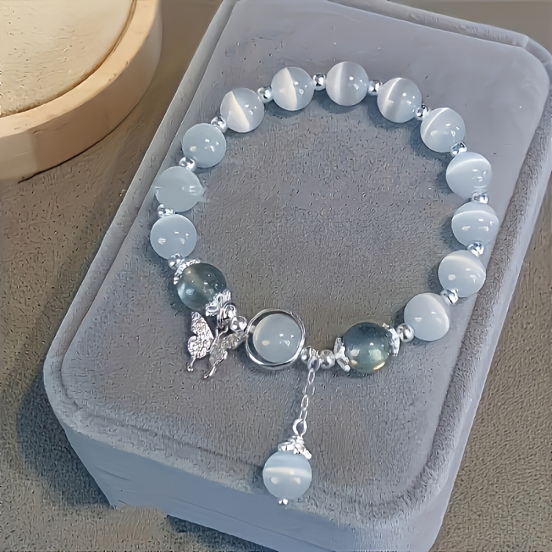 

Bracelet en Perles d'Œil de Chat en Verre avec Pendentif Papillon - pour Femmes et Filles