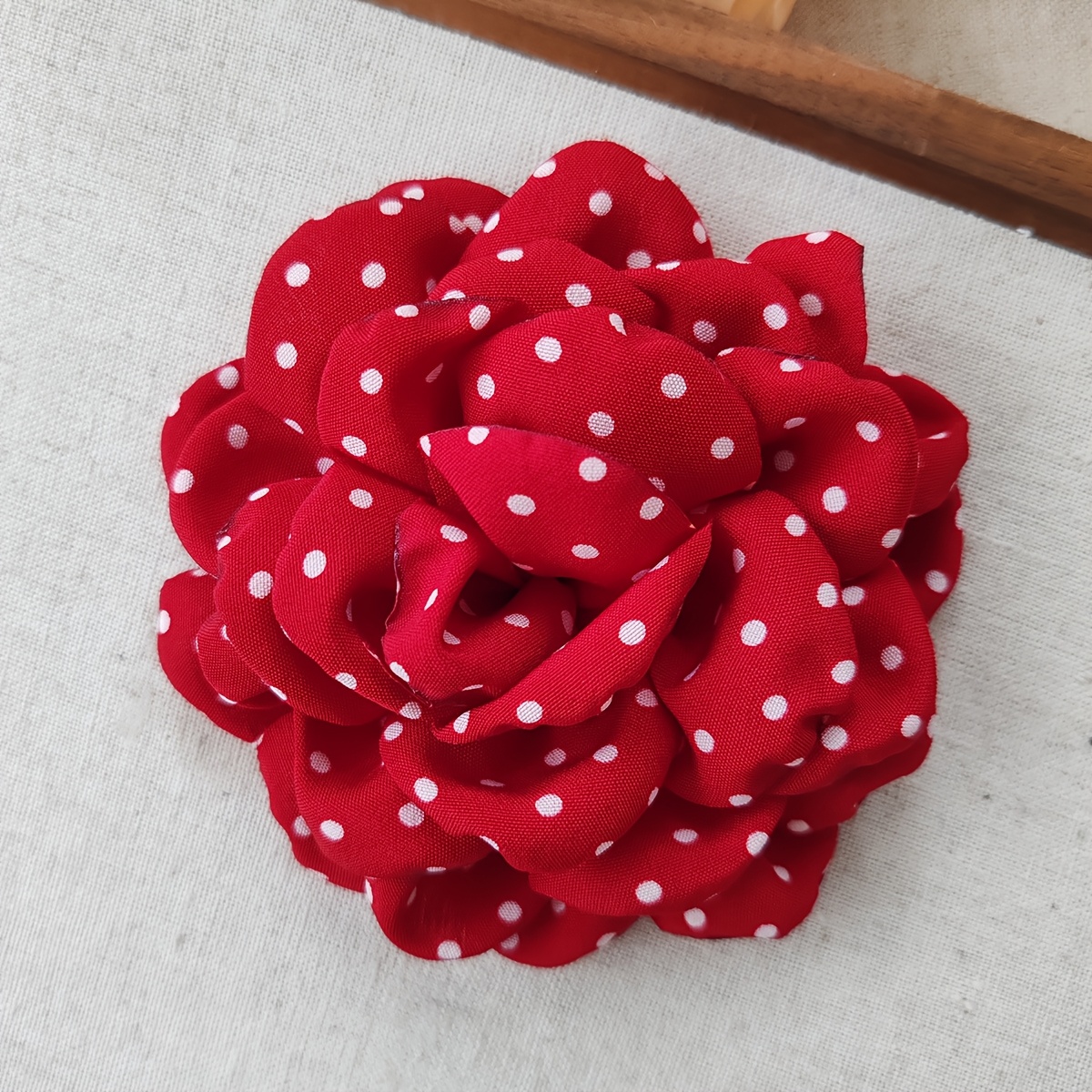 E-shop Eine handgefertigte Stoffblumen-Brosche mit verspieltem Polka-Dot-Material ist ein stilvolles Accessoire, das sich für verschiedene Anlässe
