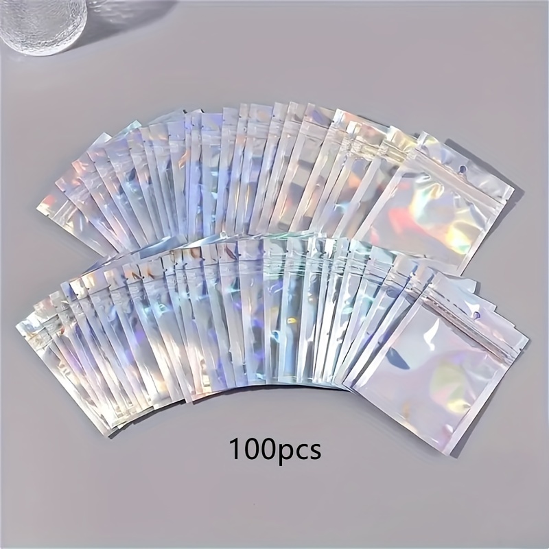 E-shop 50/100 Stück Transparente Laser Farbe Schmuck Aufbewahrungsbeutel für Kleinunternehmen - für Ohrringe, Halsketten, Armbänder, Ringe und mehr!